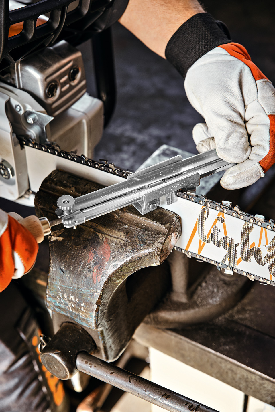 Una persona con una guía de portalimas STIHL en una espada STIHL Light 04